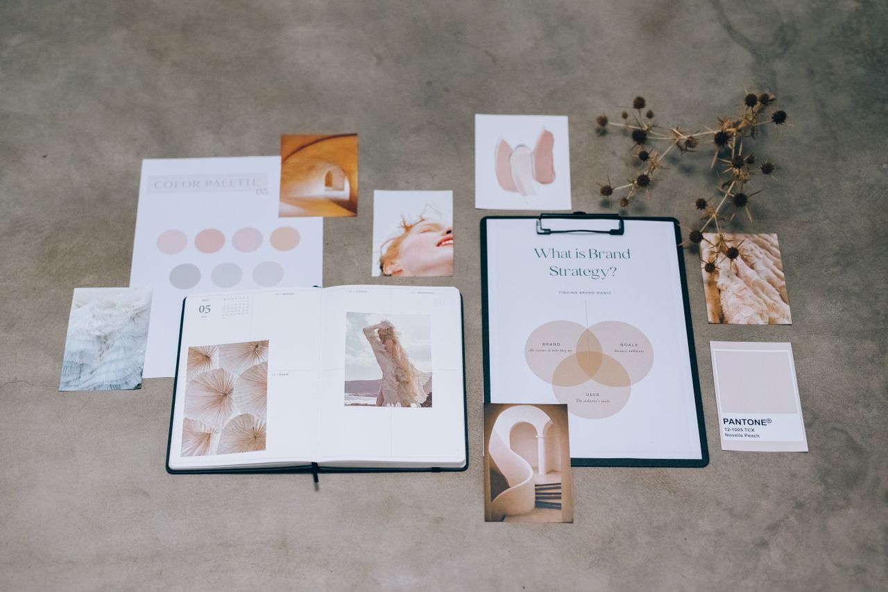 about-06 A flat lay of branding elements with color palettes and strategic planning documents on a concrete surface.